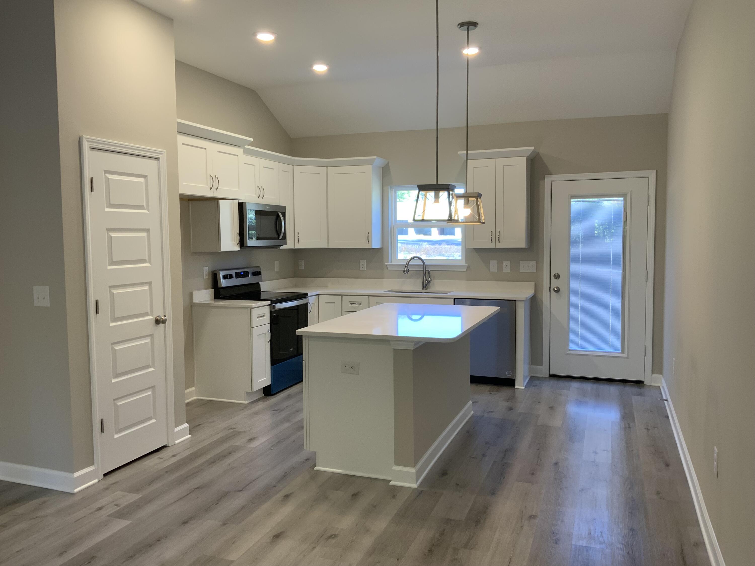 113 Shady Lane Crestview, FL 32536 - Photo 4 of 8 a kitchen with kitchen island a sink stainless steel appliances and window