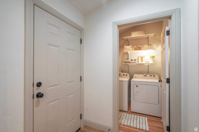 1504 Rome Way Apple Valley, UT 84737 - Photo 8 of 22 Dedicated laundry area featuring white appliances and wall-mounted shelving for organization