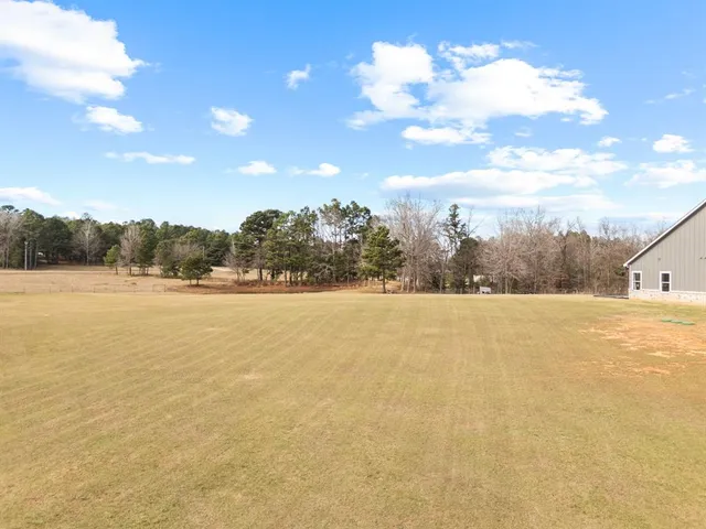 a view of house with yard and ocean view