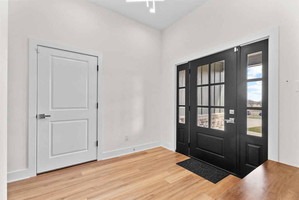 12754 Ridgeway Court Winona, TX 75792 - Photo 5 of 38 a view of an empty room with wooden floor and a window