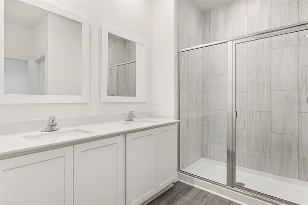 a bathroom with a shower sink and vanity