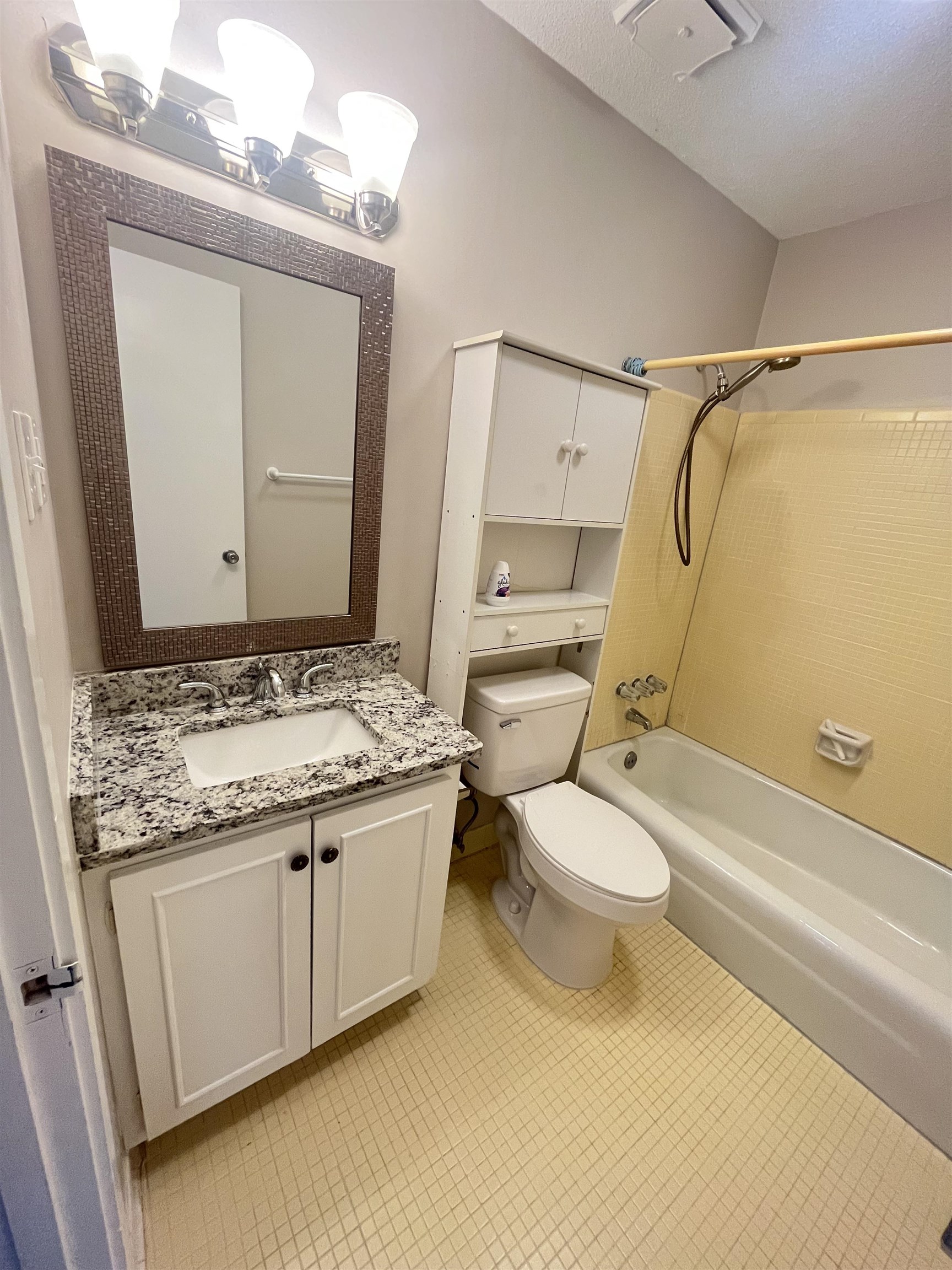 5763 Barfield Road, Unit 5763 Memphis, TN 38120 - Photo 20 of 21 a bathroom with a granite countertop toilet sink and mirror