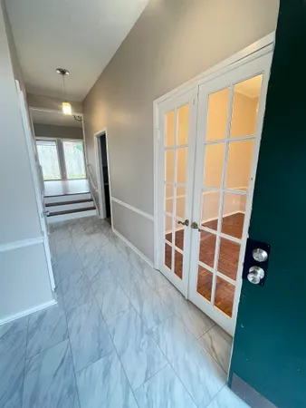 a view of a hallway view with wooden floor and staircase