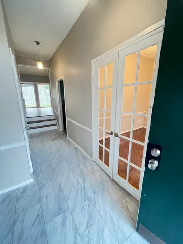 a view of a hallway view with wooden floor and staircase