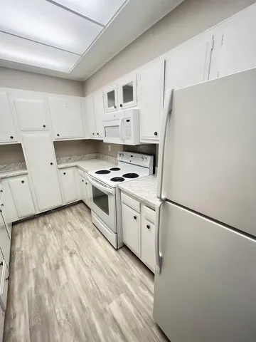 a kitchen with a sink a stove and cabinets