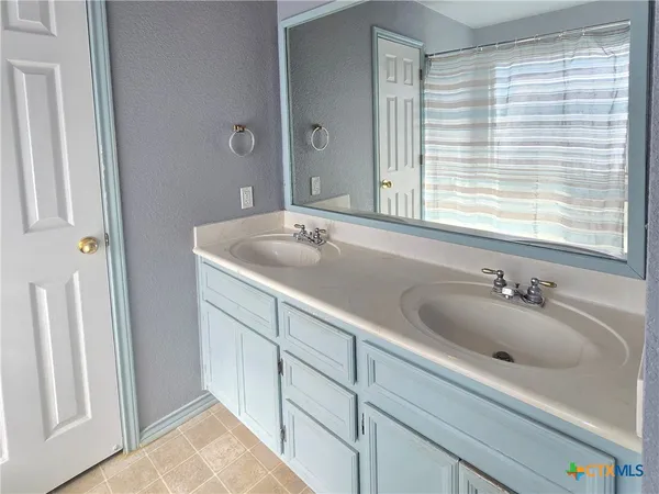 a bathroom with a sink and a large mirror