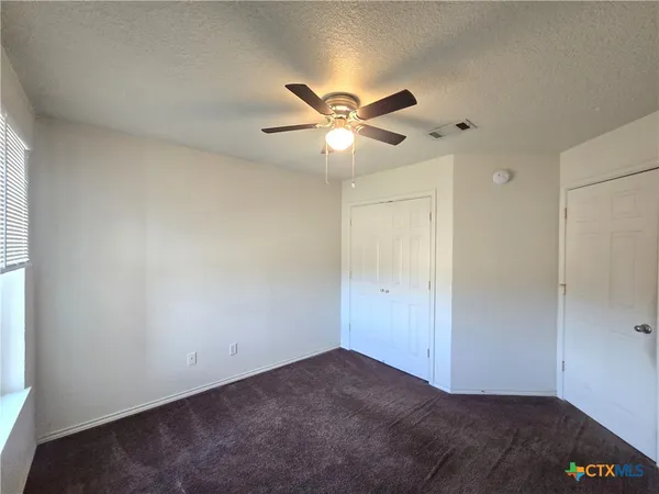 a view of a big room with carpet