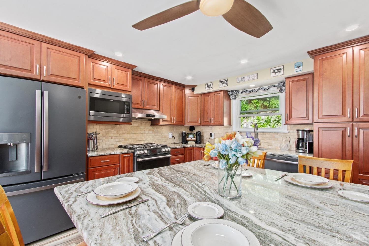 40 Emmans Road Ledgewood, NJ 07852 - Photo 11 of 24 a kitchen with stainless steel appliances granite countertop a refrigerator a stove top oven a sink dishwasher and white cabinets with wooden floor