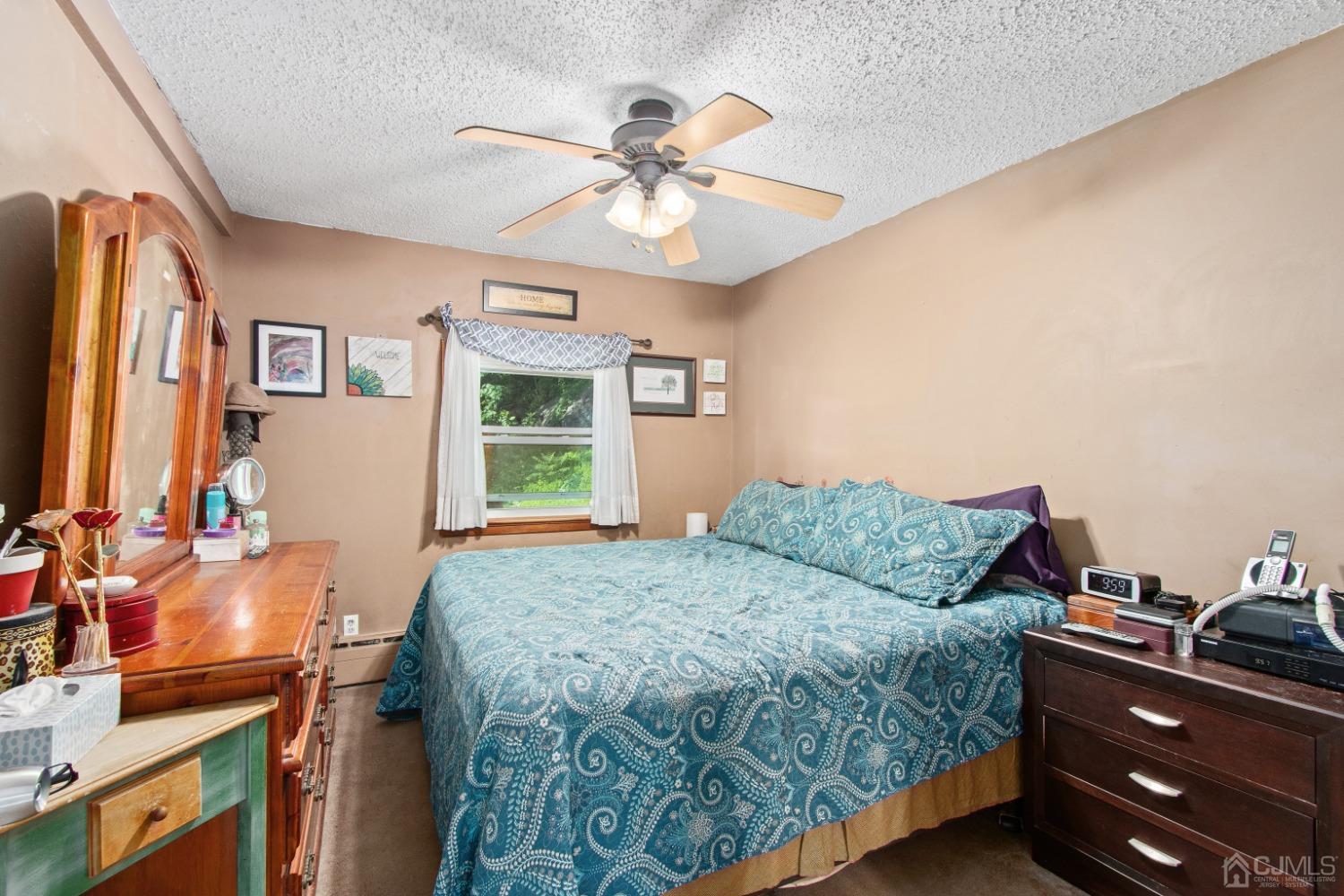 40 Emmans Road Ledgewood, NJ 07852 - Photo 12 of 24 a bedroom with a bed and a chandelier