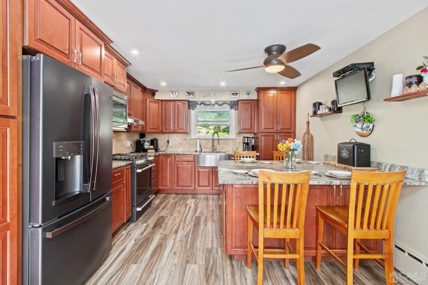 40 Emmans Road Ledgewood, NJ 07852 - Photo 8 of 24 a kitchen with stainless steel appliances granite countertop a refrigerator a sink dishwasher a stove and a dining table with wooden floor