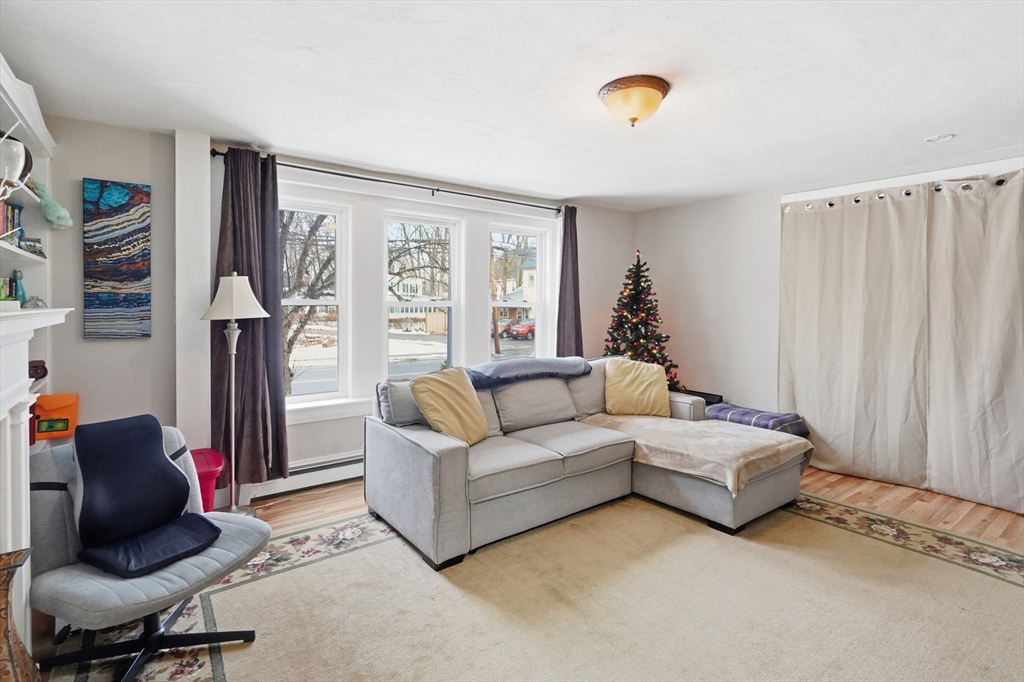 72 Main Street Pepperell, MA 01463 - Photo 19 of 26 a living room with furniture and a window