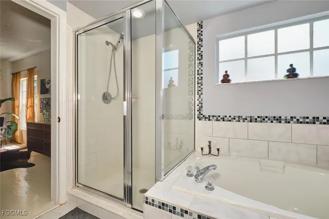 a bathroom with a tub and shower