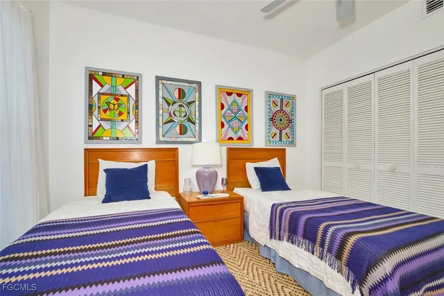 a bedroom with a bed and painting on the wall