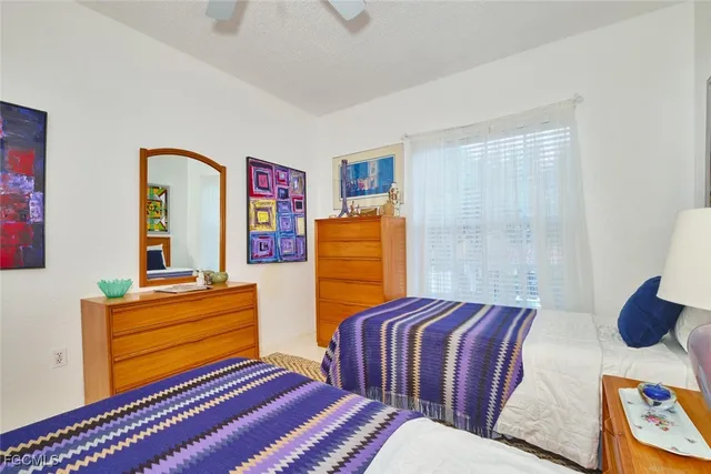 a bedroom with two beds and a dresser