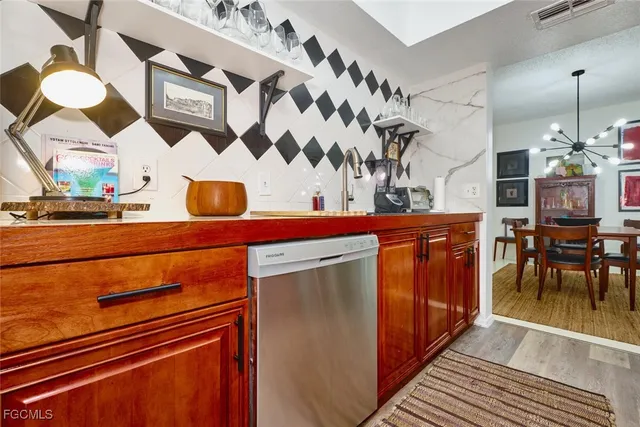 a kitchen with stainless steel appliances a stove and cabinets