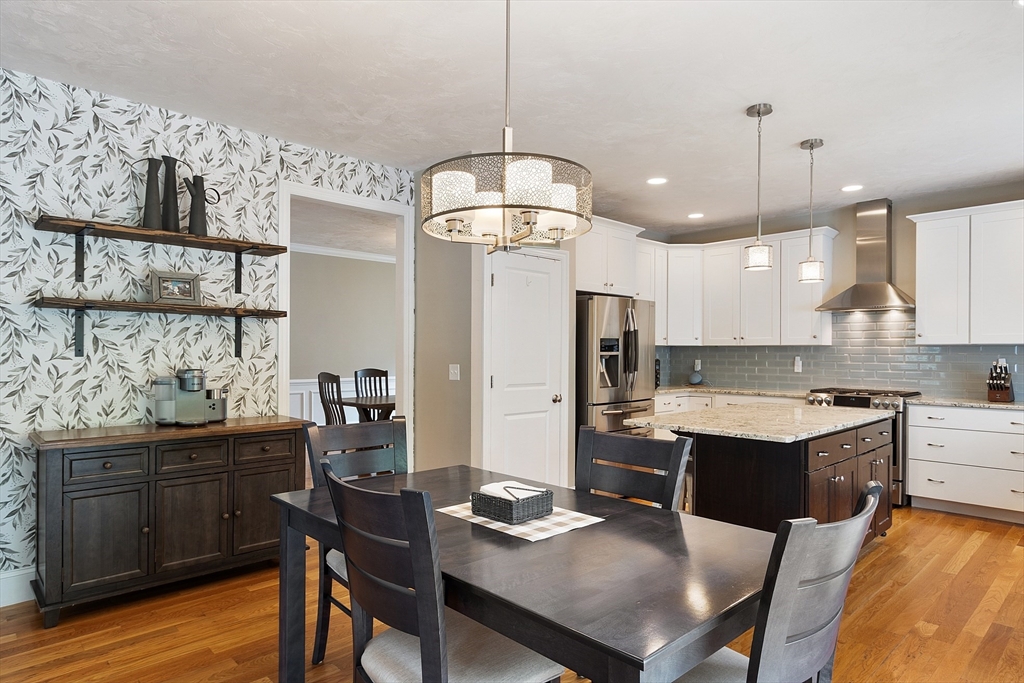 46 Jordan Road Holden, MA 01520 - Photo 5 of 42 a kitchen with a dining table cabinets appliances and wooden floor