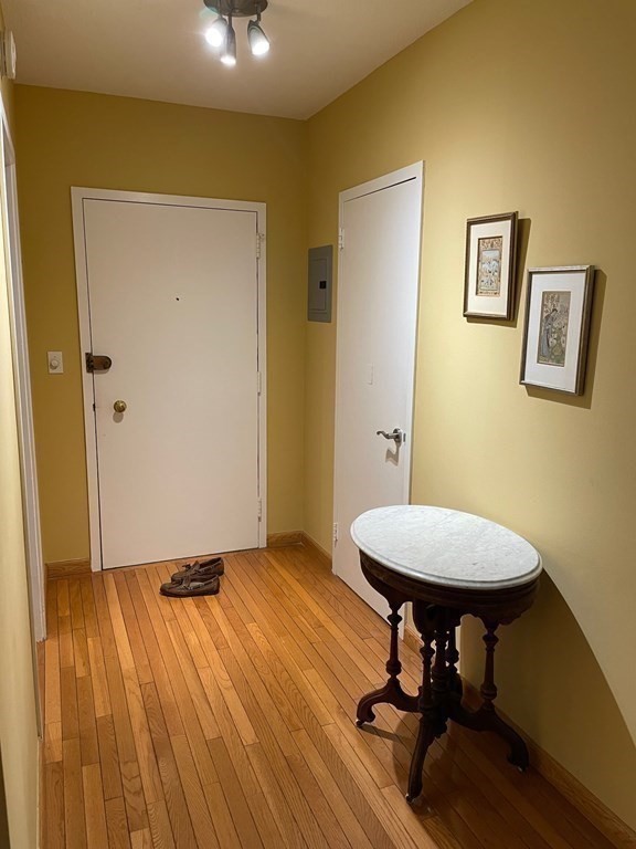 22 Chestnut Place, Unit 316 Brookline, MA 02445 - Photo 16 of 19 a view of a room with a wooden floor and a table