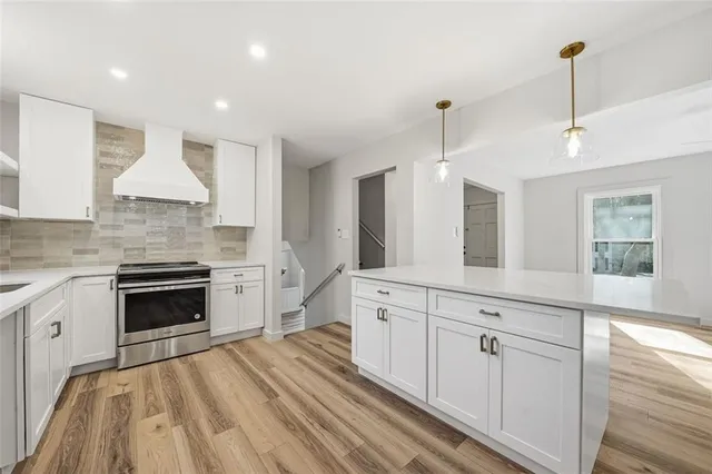 a kitchen with white cabinets and white appliances