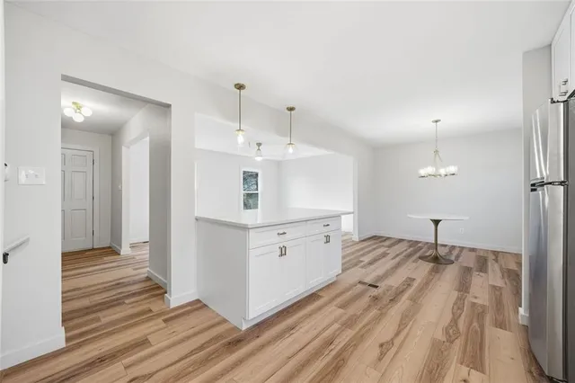 a open white kitchen with cabinets