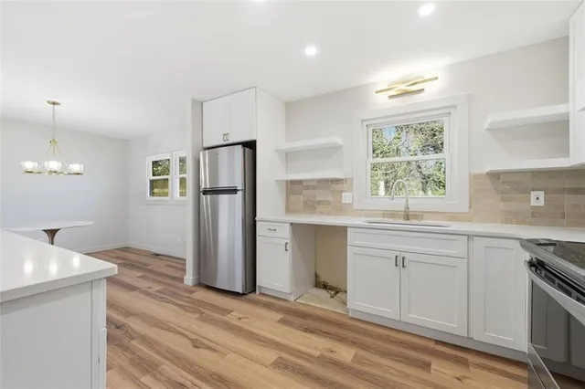a kitchen with a refrigerator and a sink