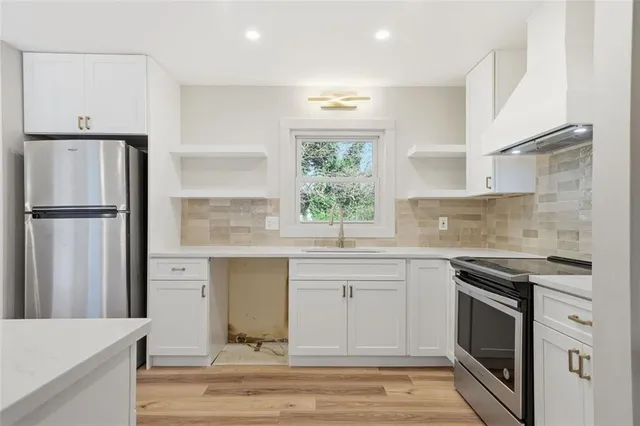 a kitchen with a sink stove and refrigerator