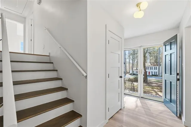 a view of entryway with stairs and wooden floor