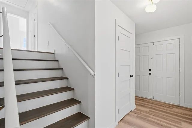 a view of entryway with wooden floor and stairs