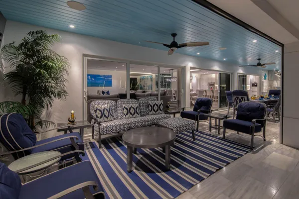 a dining room with stainless steel appliances a table and chairs