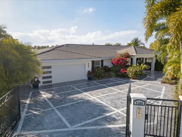 a kitchen with stainless steel appliances granite countertop a stove a sink a refrigerator and a microwave