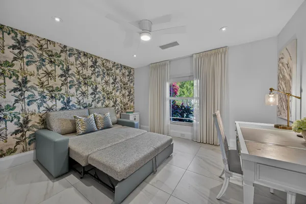 a living room with lots of furniture and kitchen view