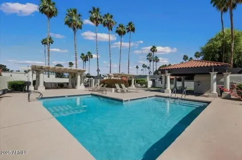 a view of a house with swimming pool and sitting area