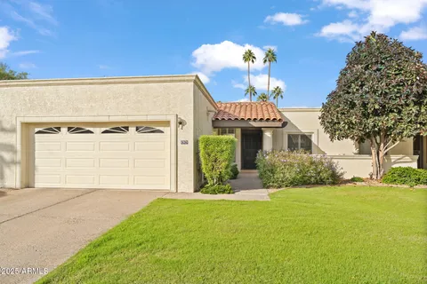 a front view of a house with a yard and garage