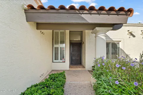 a view of a house with potted plants