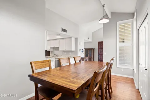 a dining table with chairs and window