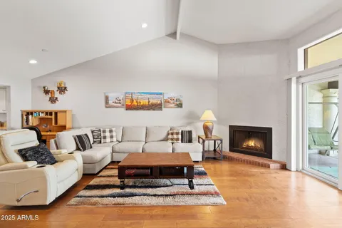 a living room with furniture a fireplace and a window