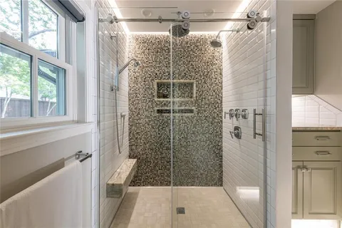 a bathroom with a shower and a sink