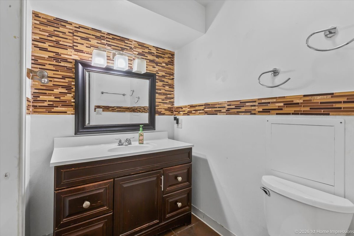 18847 May Avenue Homewood, IL 60430 - Photo 11 of 26 a bathroom with a sink a mirror and a toilet