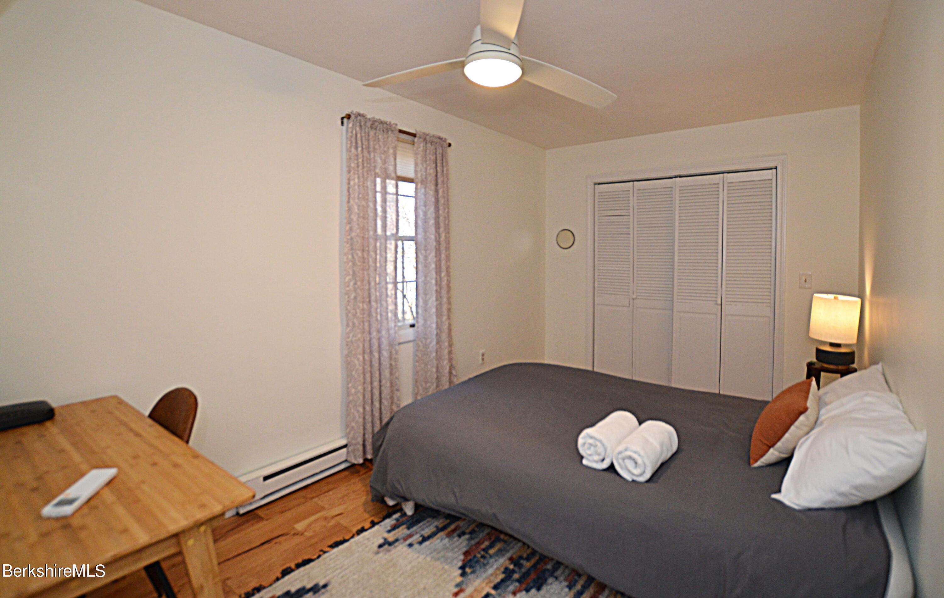 95 Middlefield Road Peru, MA 01235 - Photo 21 of 39 a bedroom with a bed and a chandelier