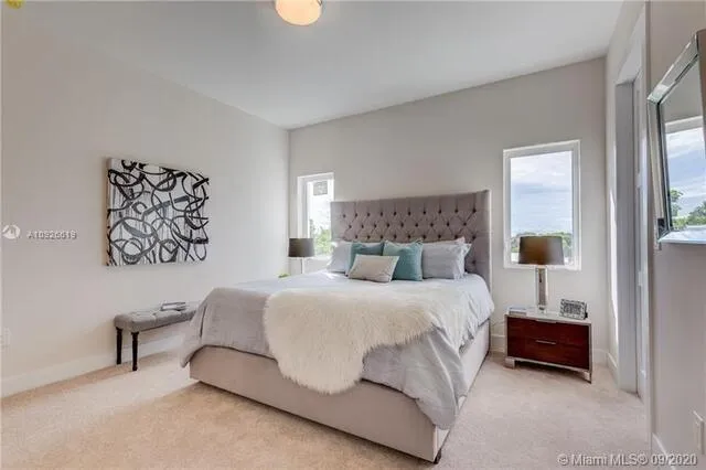 a bedroom with a bed and a night stand