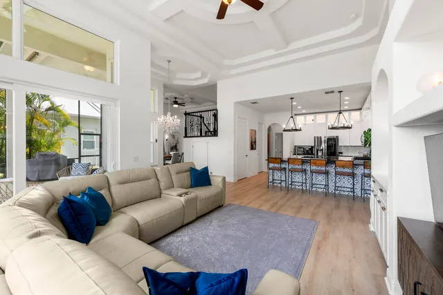 a bedroom with a large bed and a chandelier