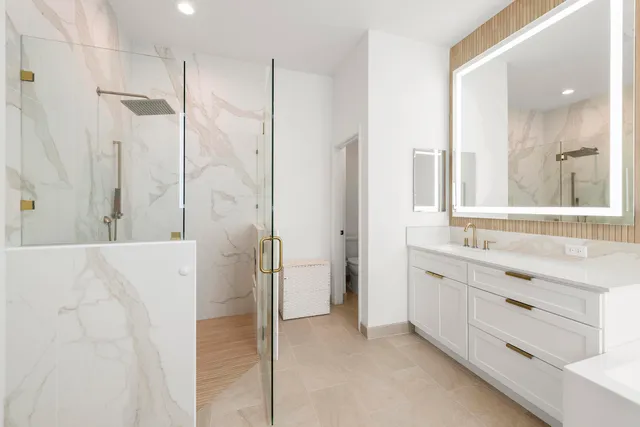 a view of a hallway with wooden floor and closet