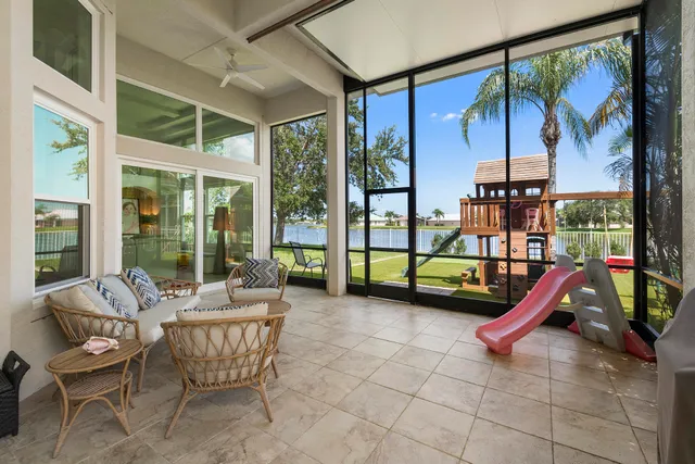 a living room with fireplace furniture and a large window