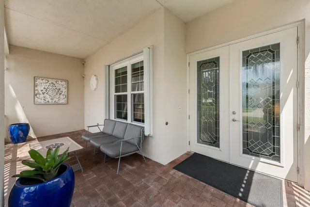 an aerial view of a house with a garden and lake view