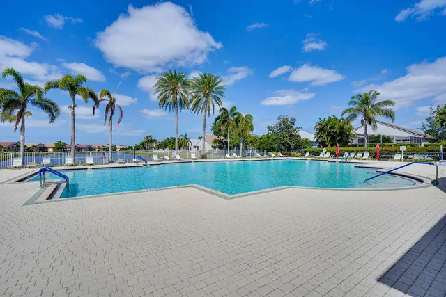 a room with pool table and windows