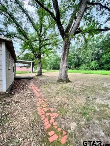 a backyard of a house with lots of green space