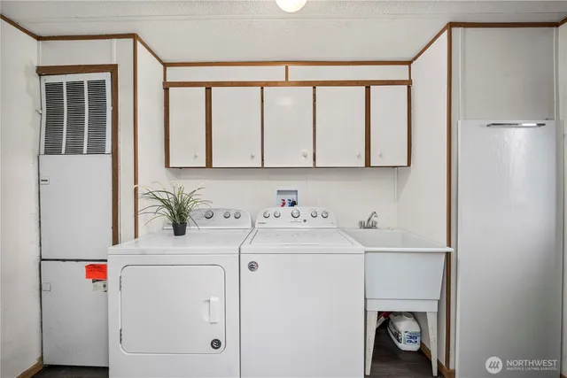 a kitchen with a stove a sink a refrigerator and cabinets