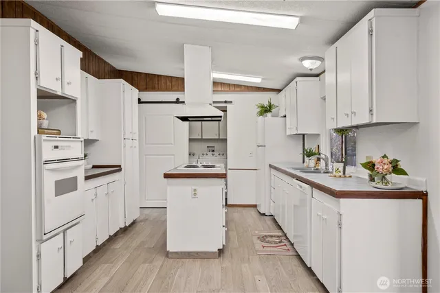 a kitchen with stainless steel appliances a sink stove and cabinets