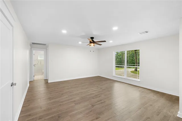 a view of a kitchen with wooden floor and electronic appliances