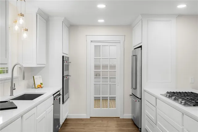 a kitchen with granite countertop a sink and cabinets