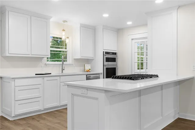 a kitchen with granite countertop a cabinets and a stove top oven